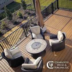 Composite deck with black aluminum railing and outdoor seating area, installed by a trusted deck contractor near me in Charlotte, NC