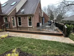 Multi-level composite deck with black aluminum railing and patio seating, built by a trusted deck contractor near me in Charlotte, NC