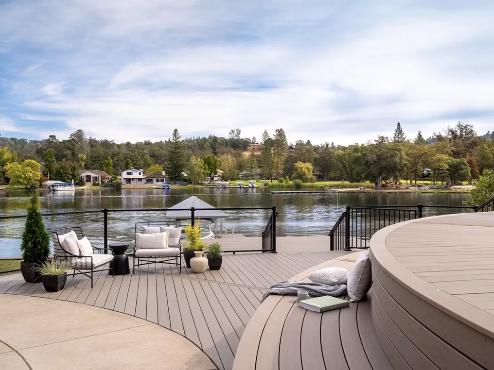 Composite deck with built-in bench seating and white railings, providing a functional and stylish outdoor area for relaxation and gatherings.