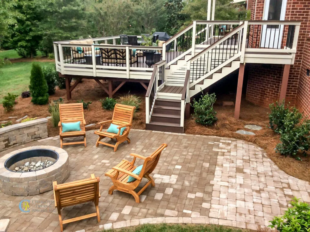 Composite deck with dark wood tones and a classic railing, offering a spacious and durable outdoor area for relaxation and entertainment.