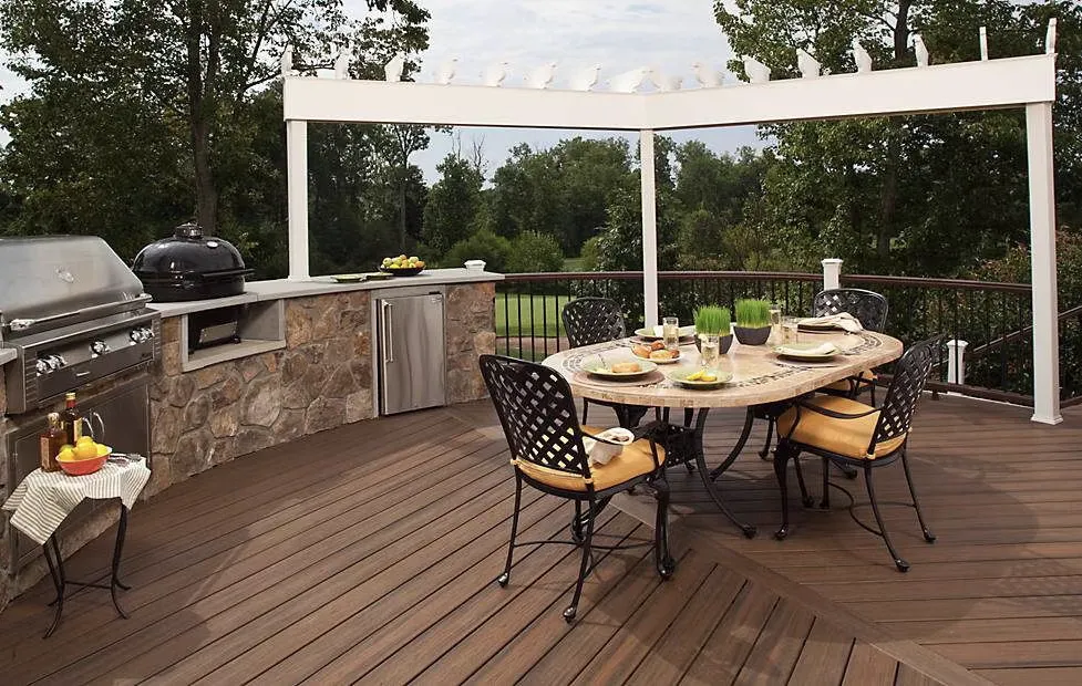 Side view of a raised deck with wooden steps and railings, showcasing a spacious outdoor area elevated from the ground for an enhanced backyard experience.